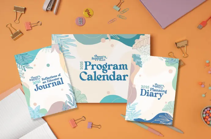 Flat lay of the 2025 Reflections of an Educator collection including a journal, program calendar, and planning diary by Phoenix Support for Educators, styled on an orange desk with stationery items.